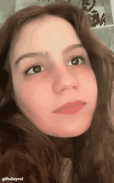a close up of a woman 's face with a gifsdayrol watermark
