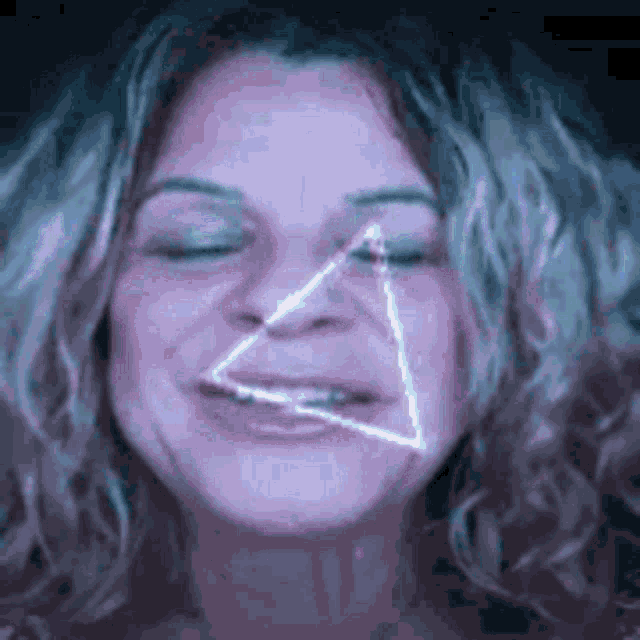 a close up of a woman 's face with a triangle coming out of her eye .