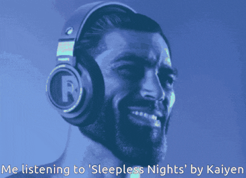 a man wearing headphones with a letter r on them