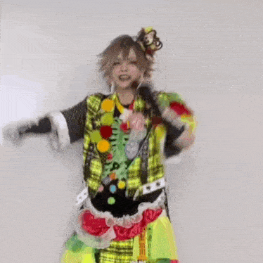 a person in a colorful costume is standing in front of a wall .