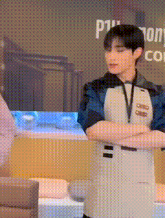 a man in an apron is standing with his arms crossed in front of a sign that says p1 .