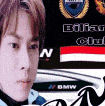 a close up of a man 's face in front of a billiard club sign