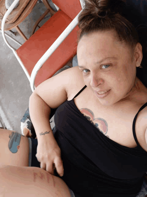 a woman with a tattoo on her arm that says " conflict "