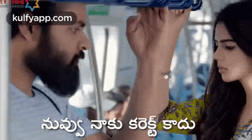 a man with a beard is holding a woman 's hand while riding a train .