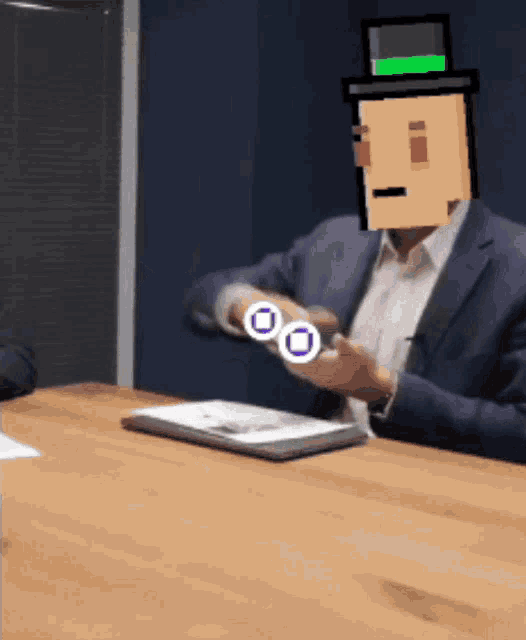 a man in a suit and top hat is sitting at a table