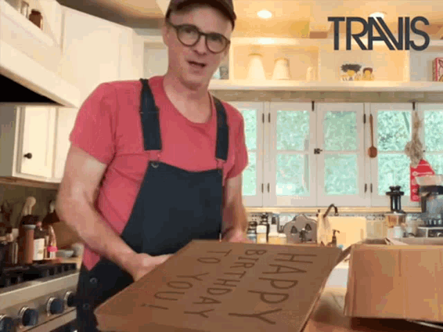 a man holds a cardboard box that says happy birthday to you