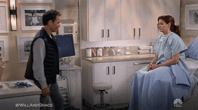 a woman in a hospital gown is sitting in a hospital bed talking to a doctor