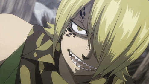 a close up of a person 's face with yellow hair and black spots on it