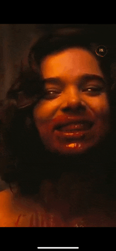 a close up of a woman 's face with blood on her lips