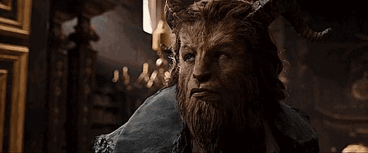 a man with horns and a beard is looking at the camera