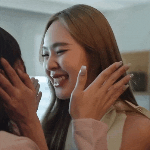 two women are hugging each other and one of them is laughing