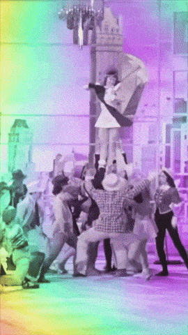 a group of people are dancing in front of a purple background