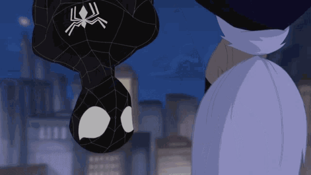 a spider man hanging upside down with a spider on his head