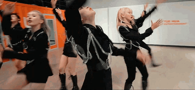 a group of women are dancing in a room with a sign that says ' tower ' on it