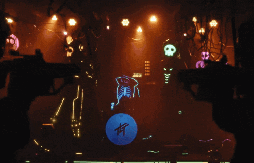 a person holding a gun in a dark room with skulls and a blue ball with the letters t on it