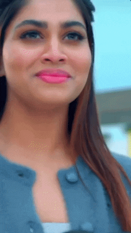 a close up of a woman 's face with pink lipstick and a blue jacket