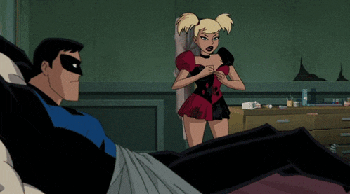 harley quinn standing next to a man in a blue shirt