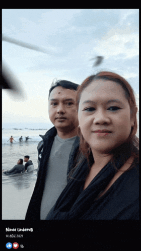 a picture of a man and a woman on a beach was taken on 14 jul 2021