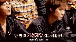 a group of young men are sitting in a row and one of them is making a face .