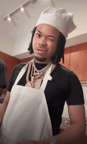 a man wearing a chef 's hat and apron