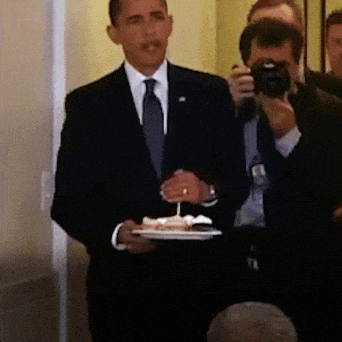a man in a suit is holding a plate of food