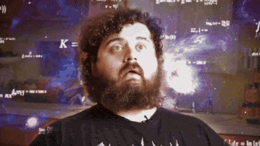 a man with a beard stands in front of a screen that says k = k