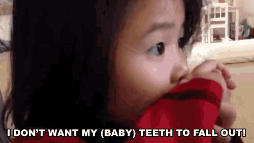a little girl is saying i don 't want my baby teeth to fall out .