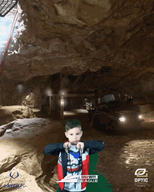 a boy in a call of duty league shirt is standing in a cave