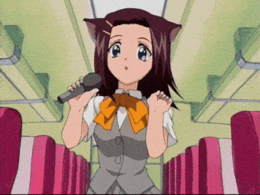 a girl with cat ears holds a microphone in her hand