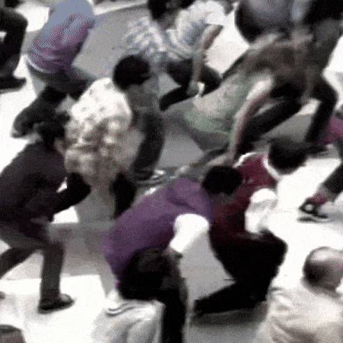 a group of people are standing in a circle on the ground .