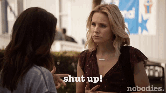 a woman is talking to another woman and the words shut up are on the bottom