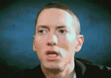 a close up of a man making a funny face with his mouth open