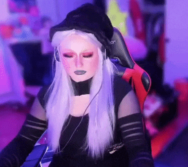 a woman with purple hair is wearing headphones and a hat that says gt on it