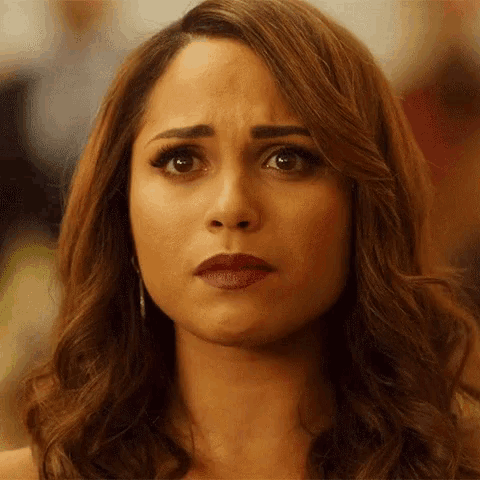 a close up of a woman 's face with a serious look on her face .