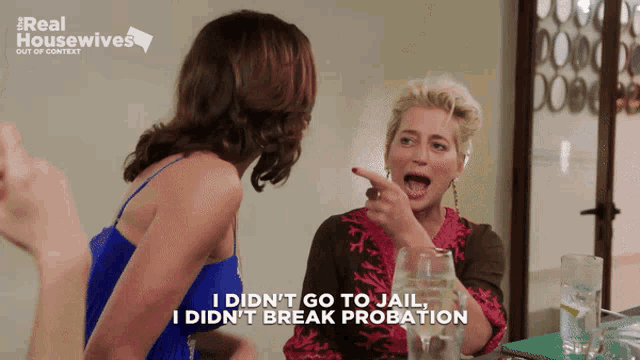 two women are sitting at a table and one says i did n't go to jail