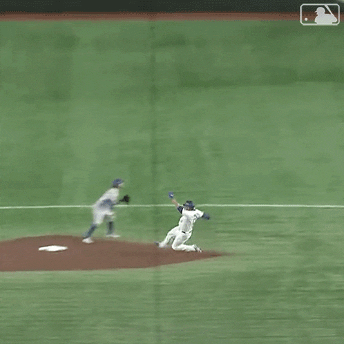 a baseball game is being played on a field with a referee and two players .