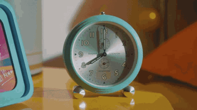 a bayard expedition alarm clock is on a table