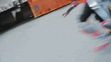 a blurry picture of a person rollerblading with a container in the background that says jd