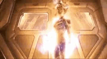 a person is standing in a room with a lot of light coming out of them .
