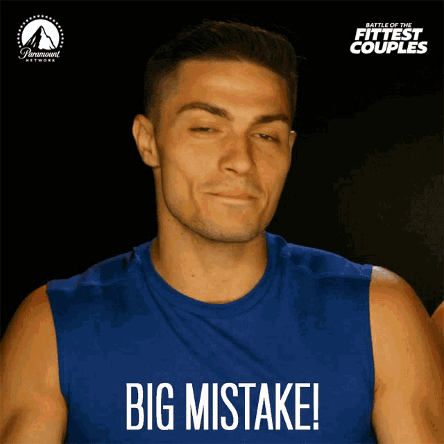 a man wearing a blue shirt that says big mistake on it