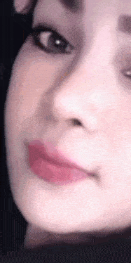 a close up of a woman 's face with pink lipstick