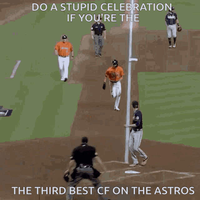 a baseball player is sliding into third base while another player watches