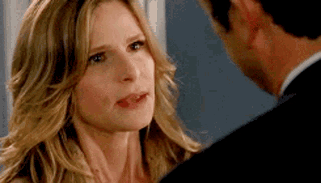 a man and a woman are looking at each other and the woman is looking at the man .