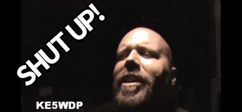 a man with a beard and the words shut up behind him
