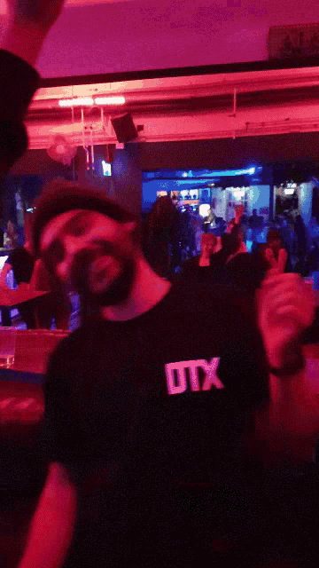 a person wearing a black shirt with the word utx on the back