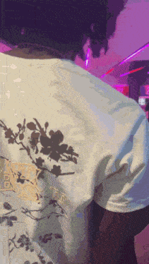 a person is wearing a white shirt with a floral design and the word beauty on it