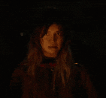 a close up of a woman 's face in the dark with a blurred background .
