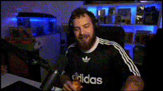 a man with a beard wearing an adidas shirt is holding a can of soda