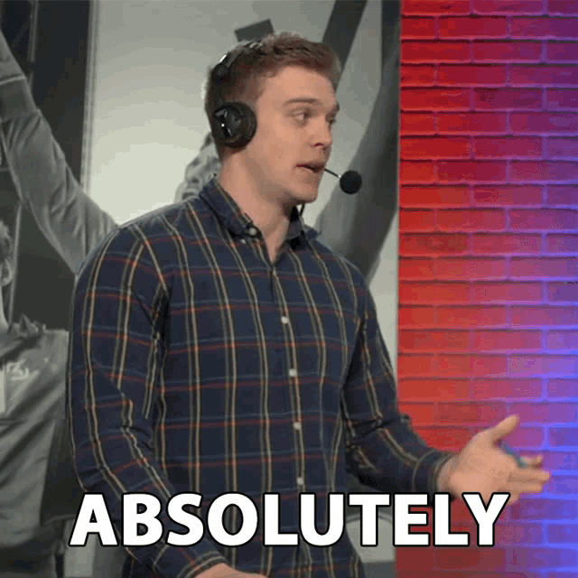 a man wearing a plaid shirt and a headset says absolutely