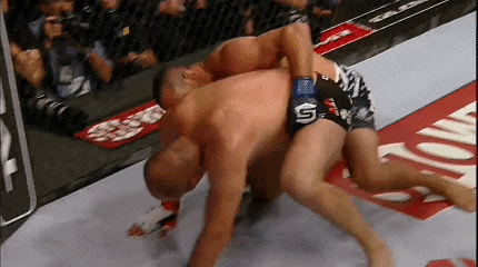 two men are wrestling with one wearing a glove that says s
